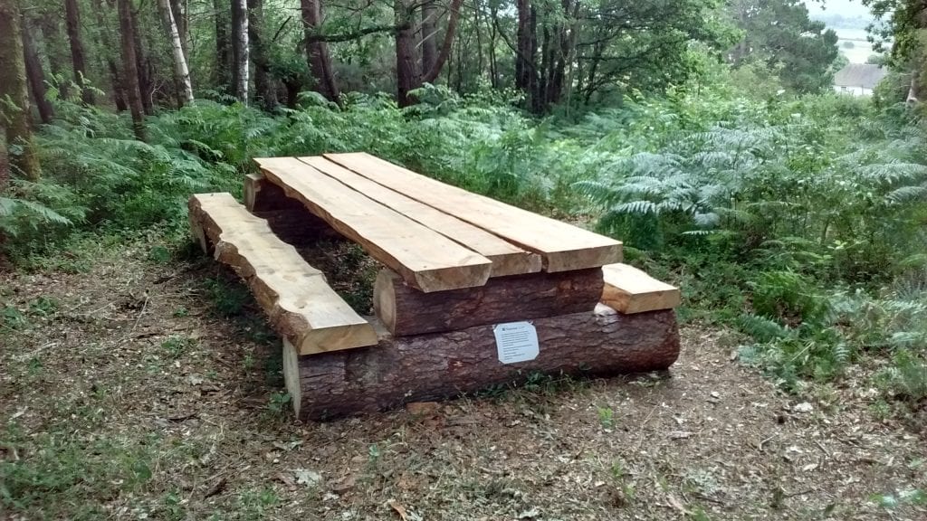 Picnic bench near windmill shaft